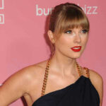Woman with red lipstick in front of pink background