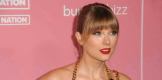 Woman with red lipstick in front of pink background