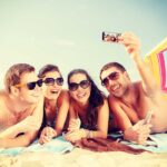 Group of friends taking a selfie on the beach