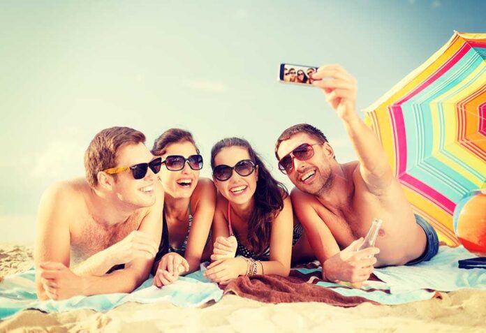 Group of friends taking a selfie on the beach