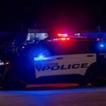 Houston police vehicle with emergency lights activated at night