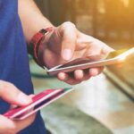 Person holding a smartphone and a credit card preparing for a digital transaction
