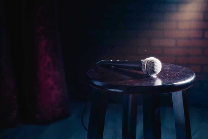 Microphone resting on a stool on stage.