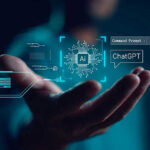 Hand holding digital AI and ChatGPT graphics.