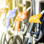 Massive Gas Price Shift – Holiday Relief! Colorful gas pump nozzles at a station.