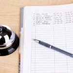 Massive Waitlist Death Toll Shocks Canada A reception desk with a bell, a pen, and a guest logbook