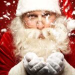 Santa Claus blowing snowflakes with a joyful expression