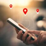 Person using a smartphone with location markers displayed on the screen