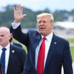 Trump’s Oil Security Promise: Constitutional Crisis Looms Man in suit waving while another man stands nearby.