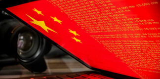 Laptop screen displaying Chinese flag and code.