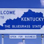 Welcome sign for Kentucky, the Bluegrass State, with a blue background
