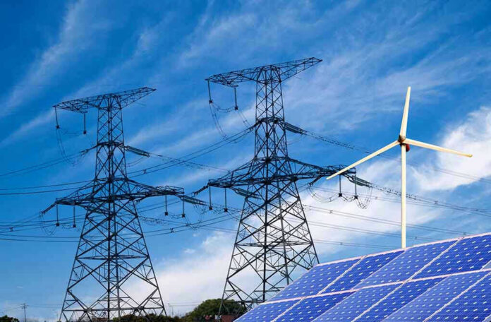 138865700 Power lines, solar panels, and wind turbine against sky.