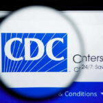 Autism Researcher in $1M CDC Fraud Storm Extradited CDC logo magnified on a screen.