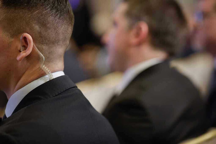 Security personnel with earpiece in a suit.