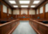 Empty courthouse courtroom with wooden benches and chairs.