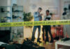 Crime scene with tape and investigators examining evidence.