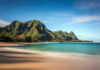 Chilling Pattern: Women Vanish in Resort Paradise Beach with mountains and clear blue water.