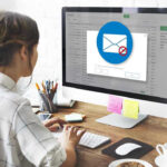 Person viewing email error on desktop computer screen