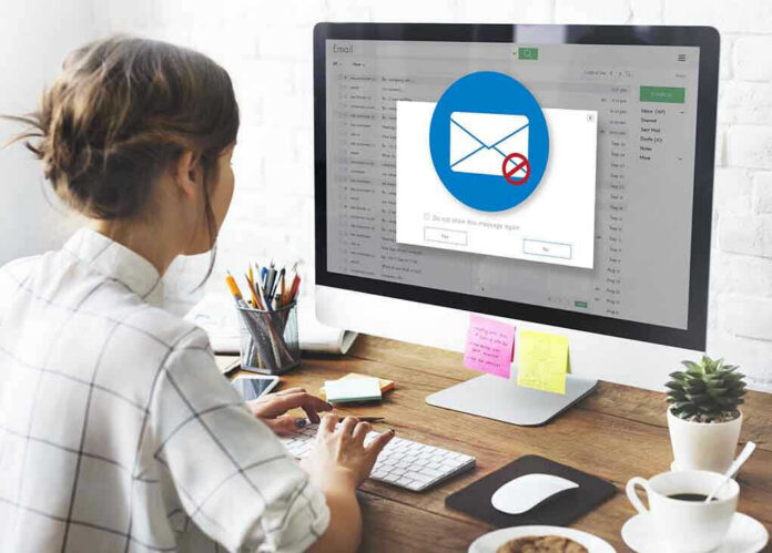 Person viewing email error on desktop computer screen