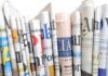 Fourth Trump Assassination Attempt: Media Blamed! A collection of rolled newspapers displaying various headlines and designs