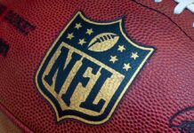 Quarterback’s Trump Moment Sparks Locker Room Drama Close-up of an NFL football with the logo prominently displayed