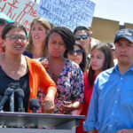 Group of people at an outdoor press event.
