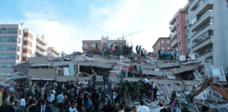 People at a collapsed building after an earthquake.