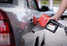 A person refueling a car at a gas station