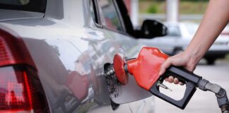 A person refueling a car at a gas station