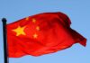 Chinese flag waving against a clear blue sky