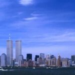 Skyline of New York City featuring the Twin Towers against a blue sky
