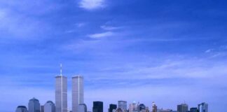 Skyline of New York City featuring the Twin Towers against a blue sky