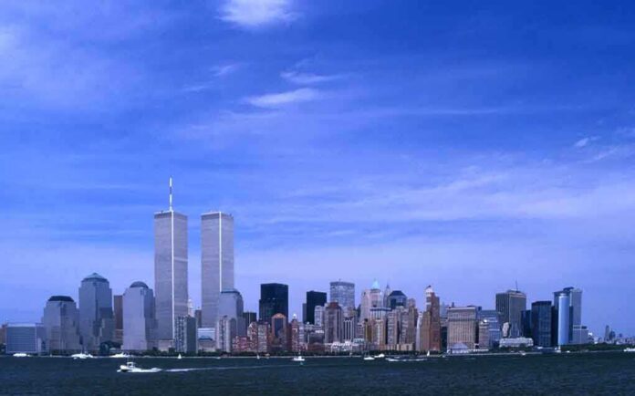 Skyline of New York City featuring the Twin Towers against a blue sky