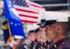 Big Wins for Vets—Hidden Tradeoffs? U.S. Marines in uniform standing in formation with flags in the background