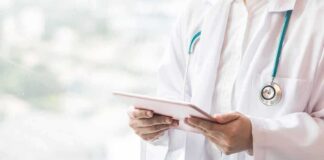Doctor with stethoscope using a tablet