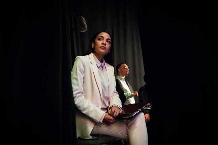 Woman in a white suit sitting backstage with a folder