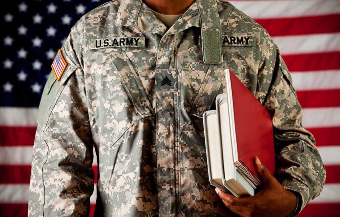 Soldier:,Ready,To,Go,Back,To,School,As,A,Student A soldier in a U.S. Army uniform holding books in front of an American flag