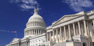 The U.S. Capitol building with its dome and columns under a blue sky