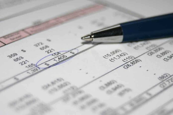 shutterstock_954645 Close-up of a financial document with highlighted numbers and a pen