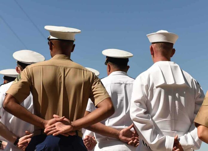 sailors and marines standing in formation with hands behind backs