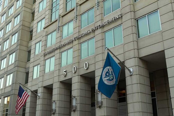 U.S. government building facade with American and blue departmental flags