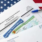 immigration forms with green card and social security card on US flag background
