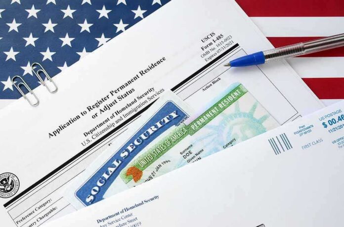 immigration forms with green card and social security card on US flag background