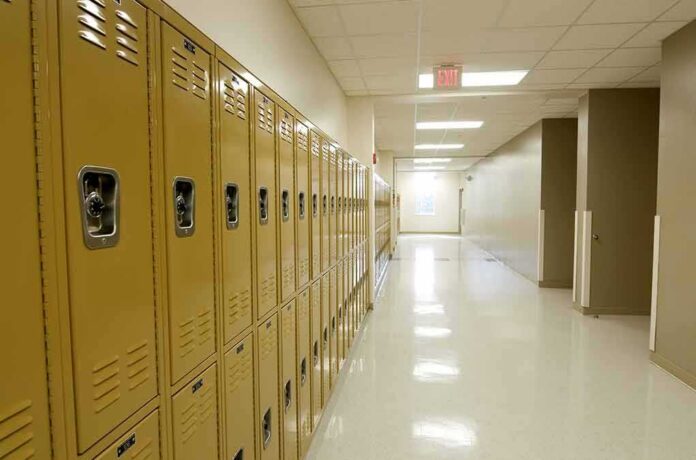 Row of yellow school lockers in an empty hallway