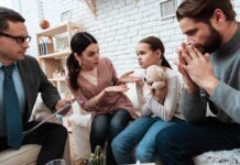 Family and counselor in tense discussion with upset child holding teddy bear