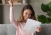 woman celebrating while reading a letter