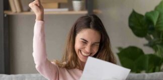 woman celebrating while reading a letter